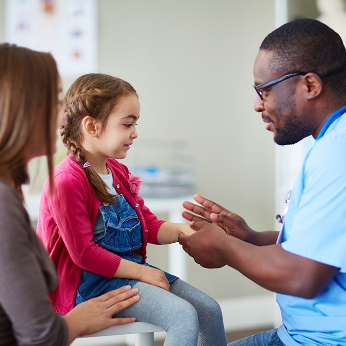 doctor checking a little girl